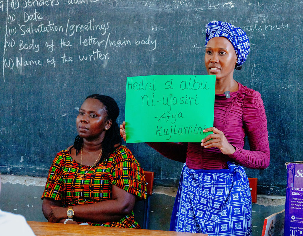 A facilitator shares a menstrual health message with students
